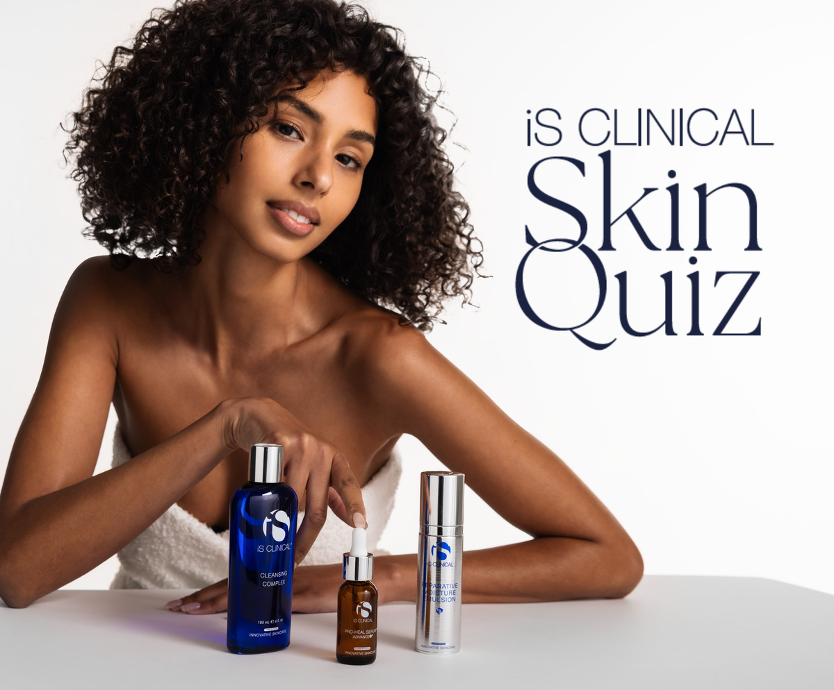 Woman with curly hair leaning on table with iS Clinical Cleansing Complex, Pro-Heal Serum Advance+, and Reparative Moisture Emulsion bottles