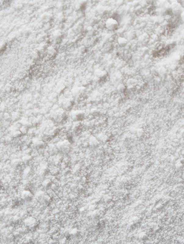 Close-up of fine white powder texture representing ectoin natural ingredient