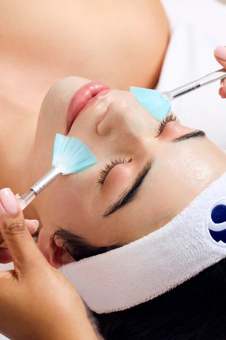 Fan brushes applying the masque during a Fire and Ice facial
