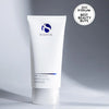 White tube of iS Clinical Tri-Active Exfoliating Masque with blue logo on grey background