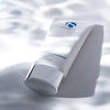 iS Clinical Warming Honey Cleanser tube with silver cap on white surface with soft shadows